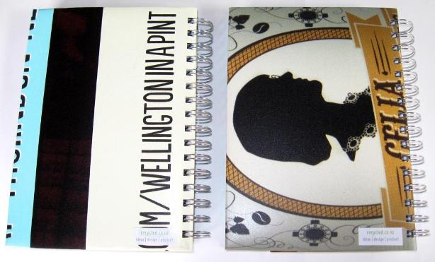 Rear view of the recycled poster notebooks featuring Celia Wade-Brown Ale